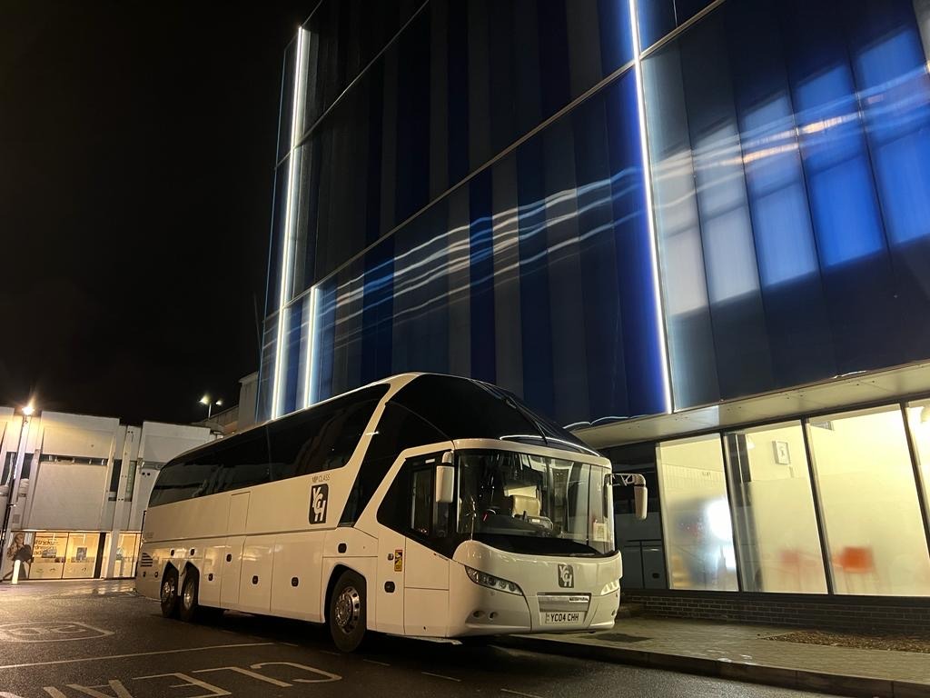 Your Coach Hire coach parked on city street